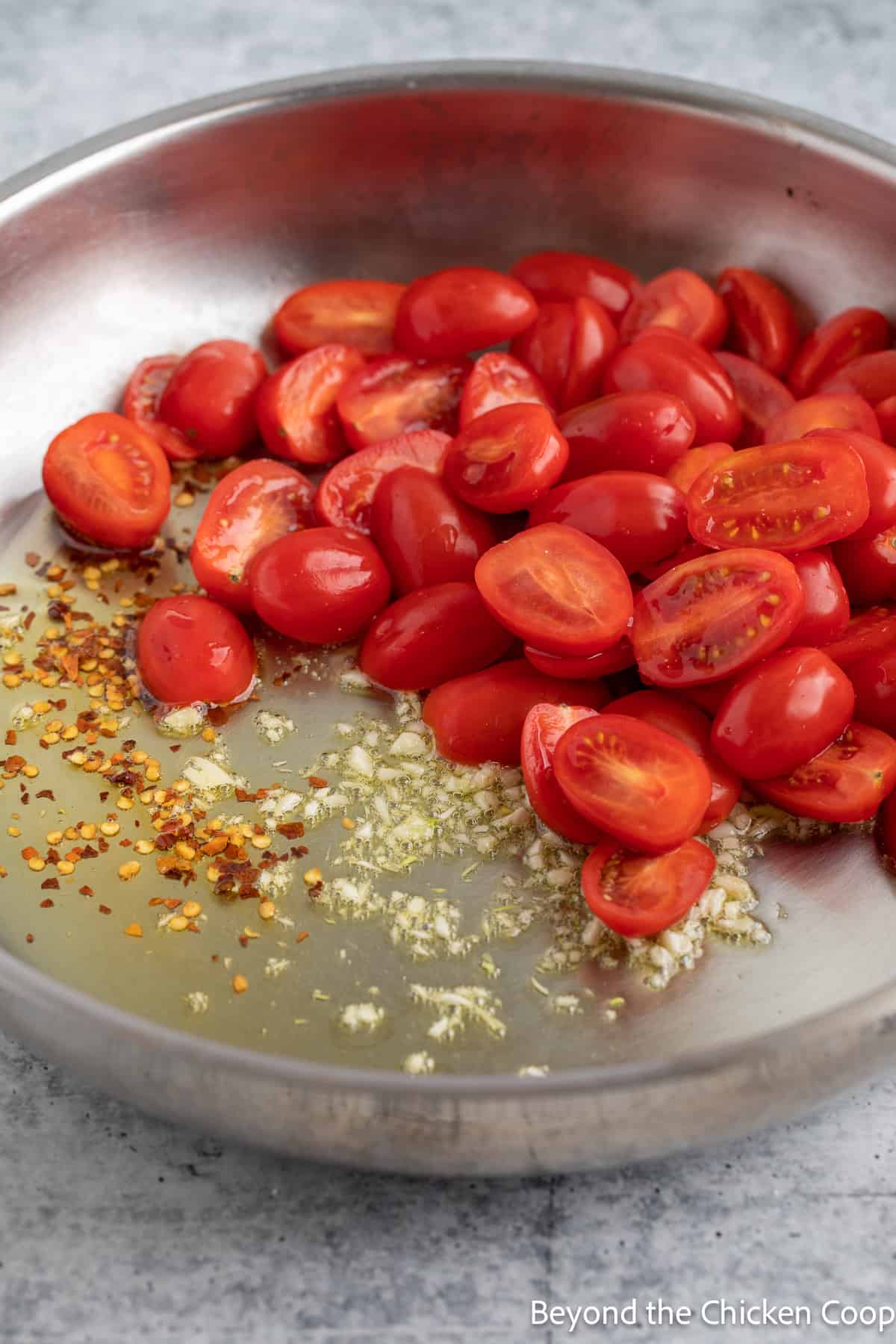 Cherry tomatoes in a saute pan. 