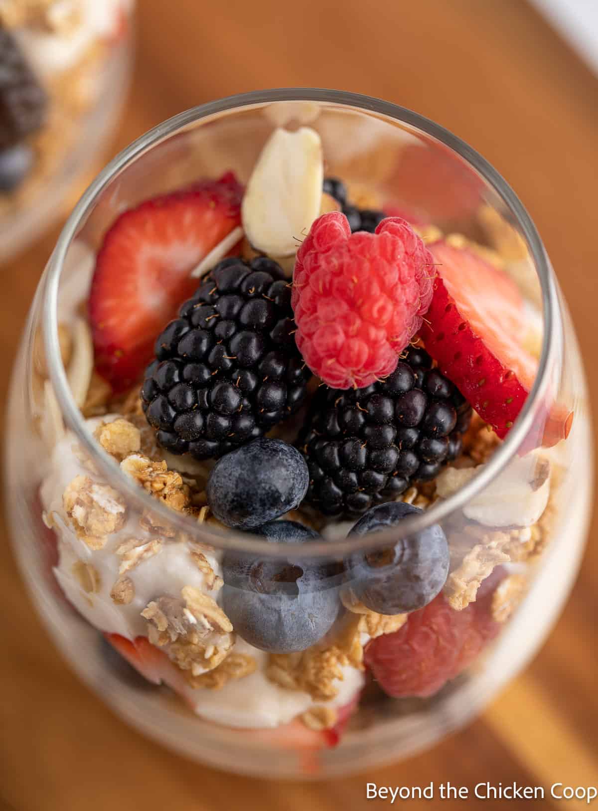 Berries and sliced almonds in a parfait. 