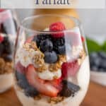 A wine glass filled with a yogurt parfait.