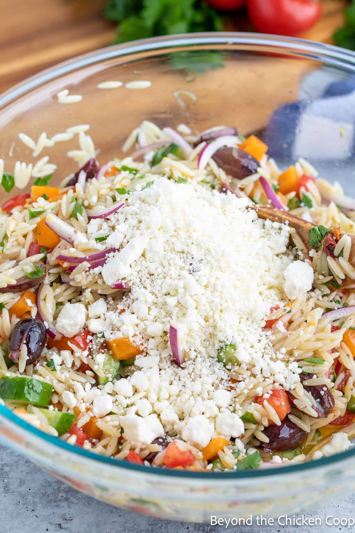 Feta cheese added to a pasta salad.