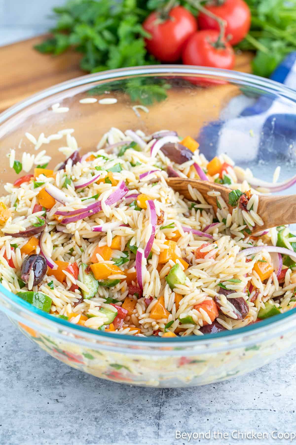 A large pasta salad in a glass bowl. 