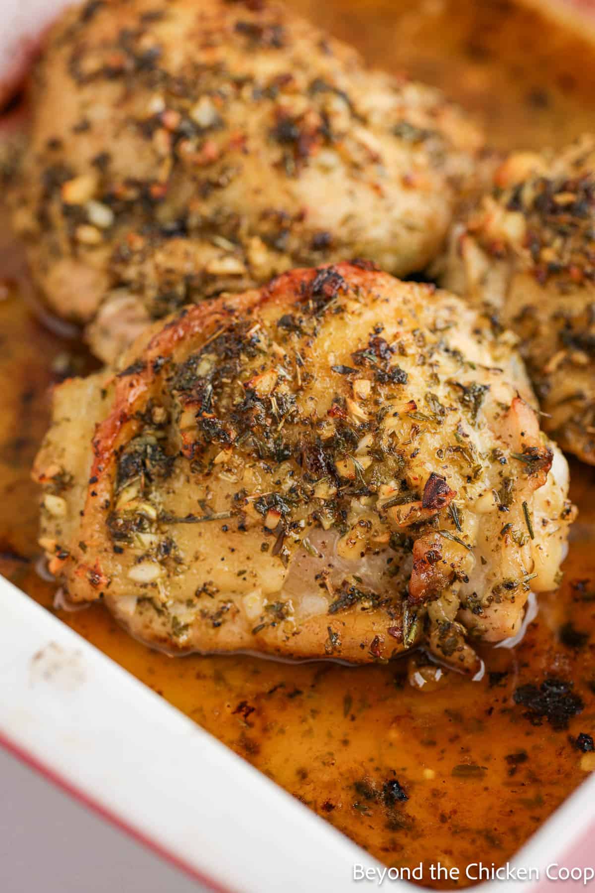 Cooked chicken thighs in a baking dish. 