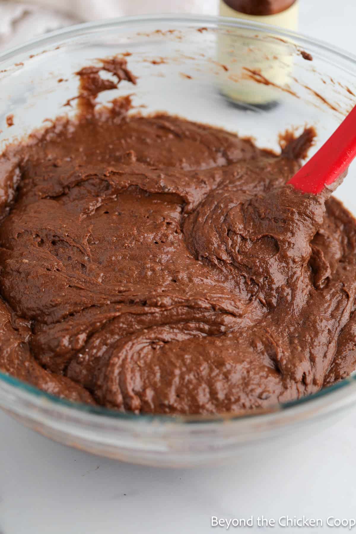Thick chocolate cake batter in a bowl. 