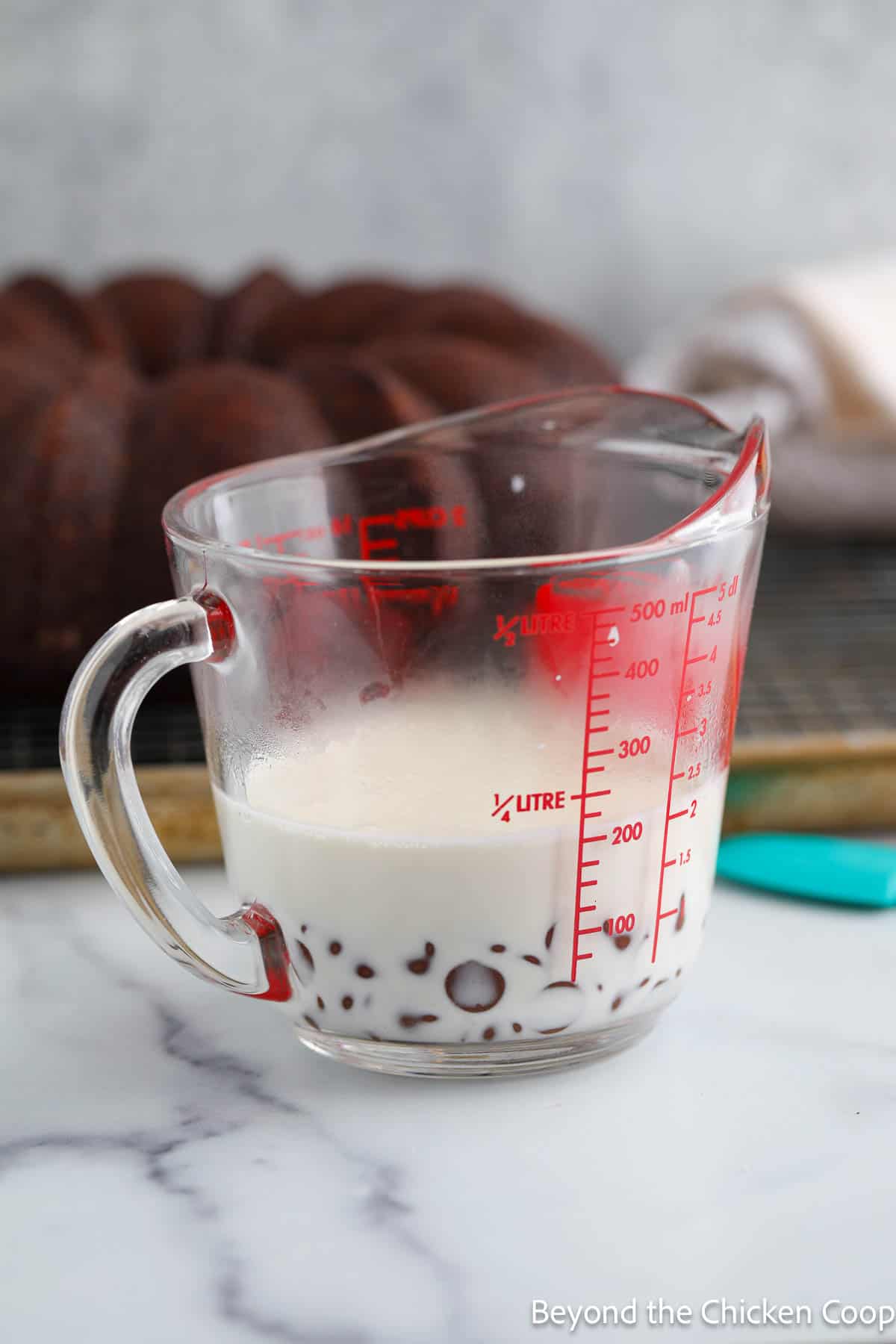 Making a chocolate glaze in a glass measuring cup. 