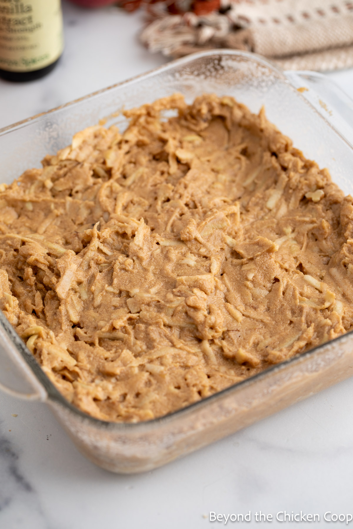 Cake batter in a glass pan.