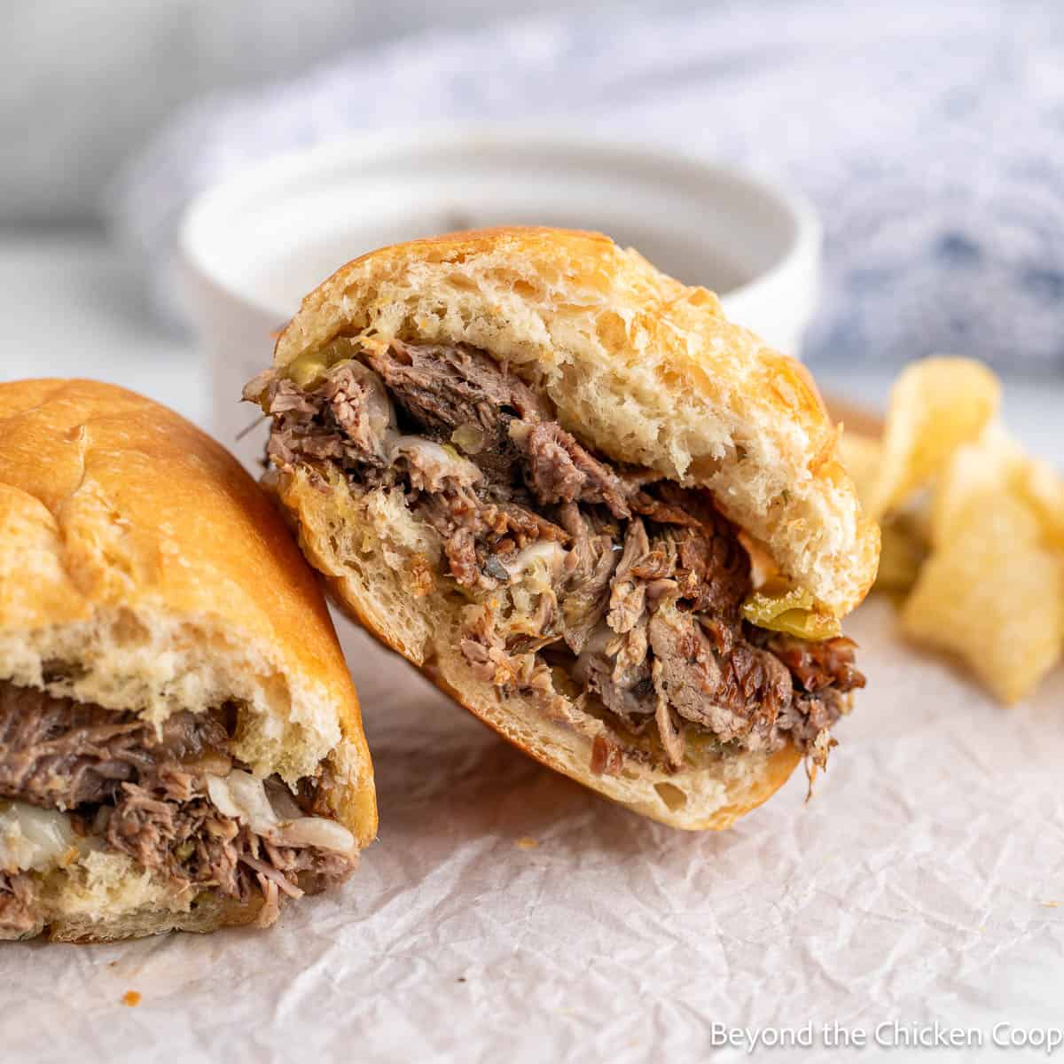 Shredded beef sandwich cut in half.