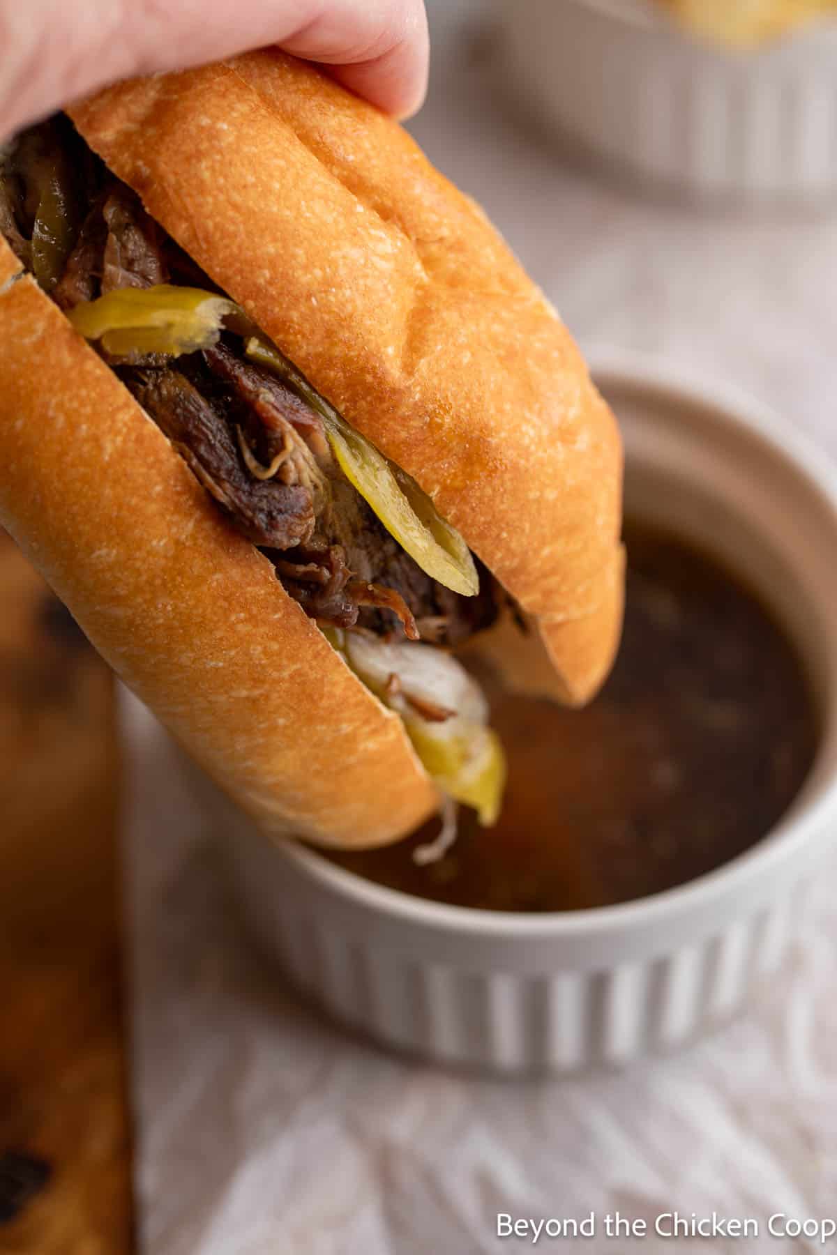 Dipping a sandwich into au jus. 