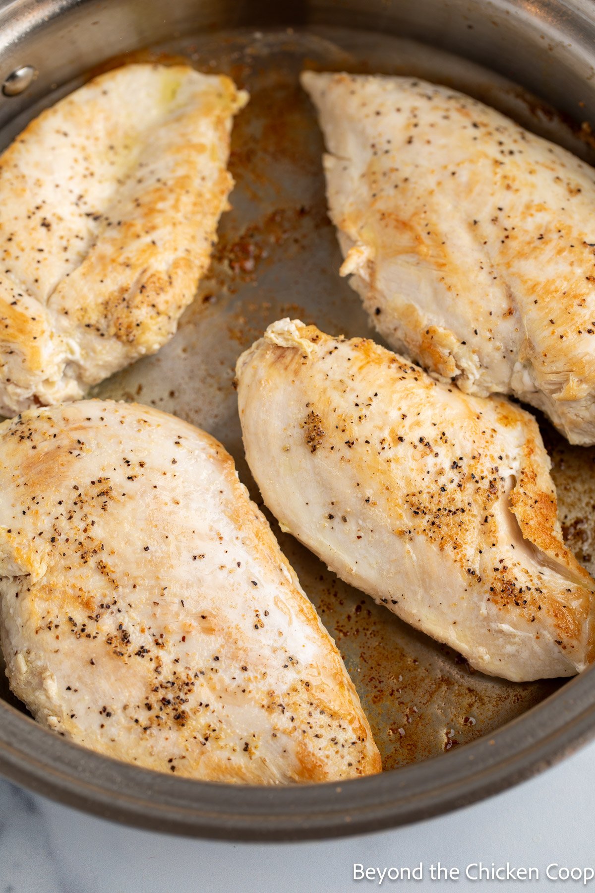 Browning chicken breasts in a skillet. 