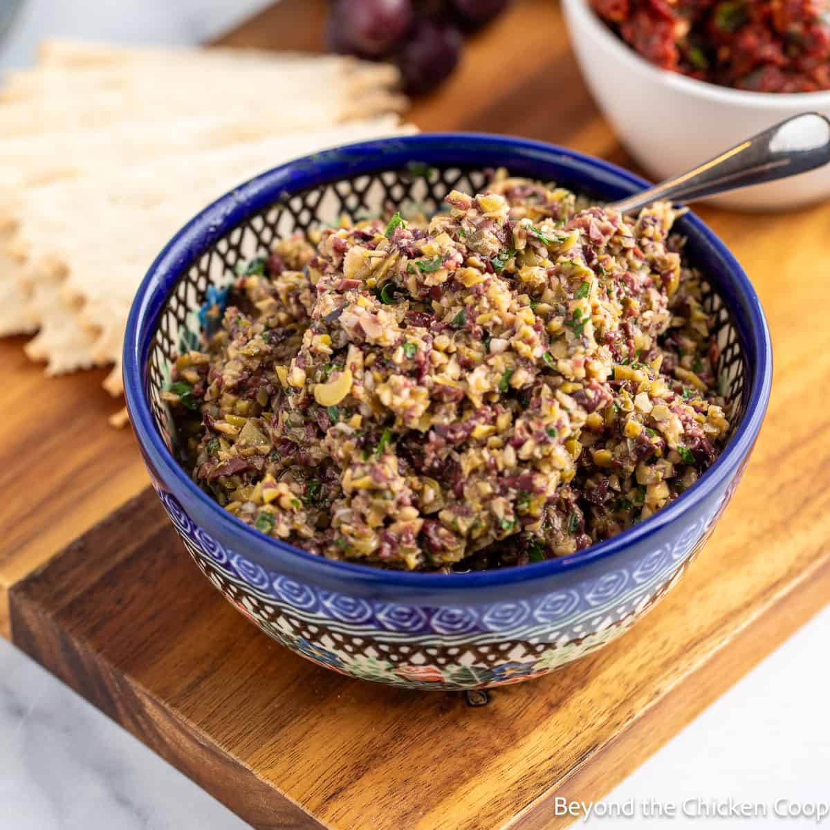 A blue patterned bowl filled with chopped olives.