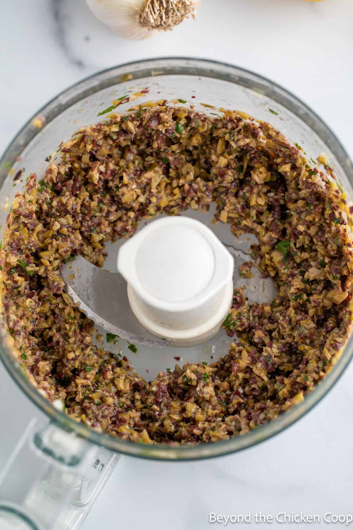 An olive mixture in a food processor. 