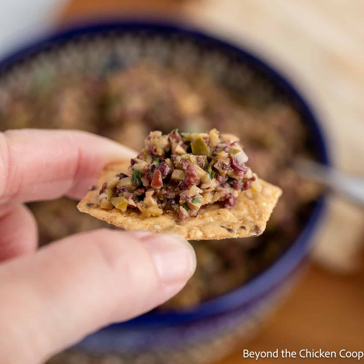 Olive tapenade on a cracker. 