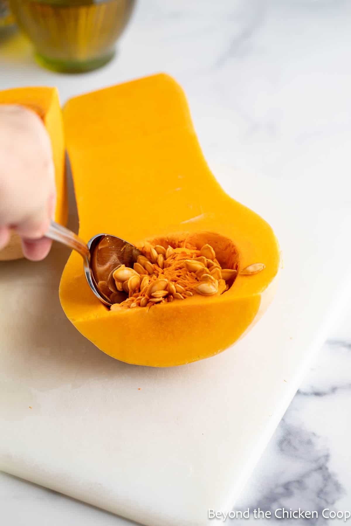 Scooping out the seeds from a squash. 
