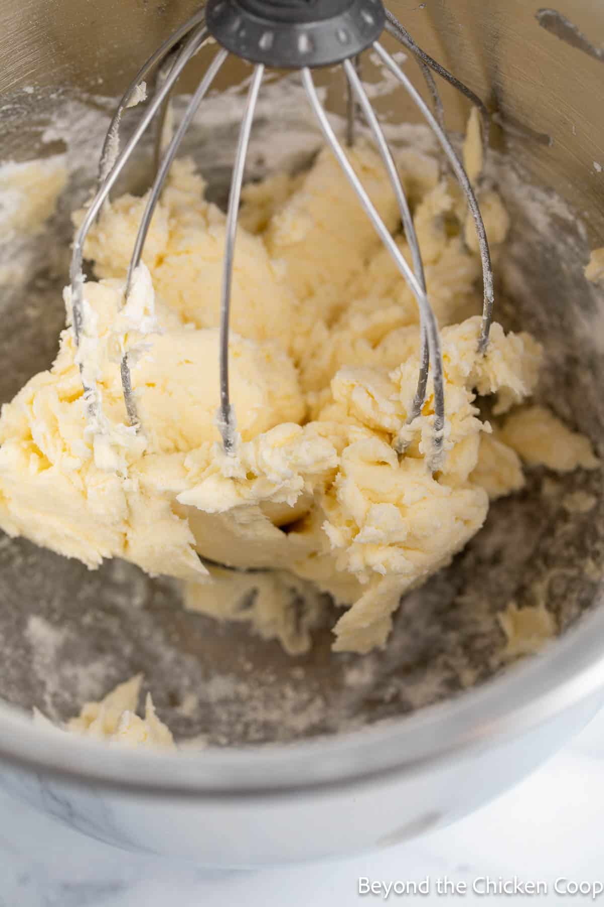 Thick butter mixture in a mixer. 