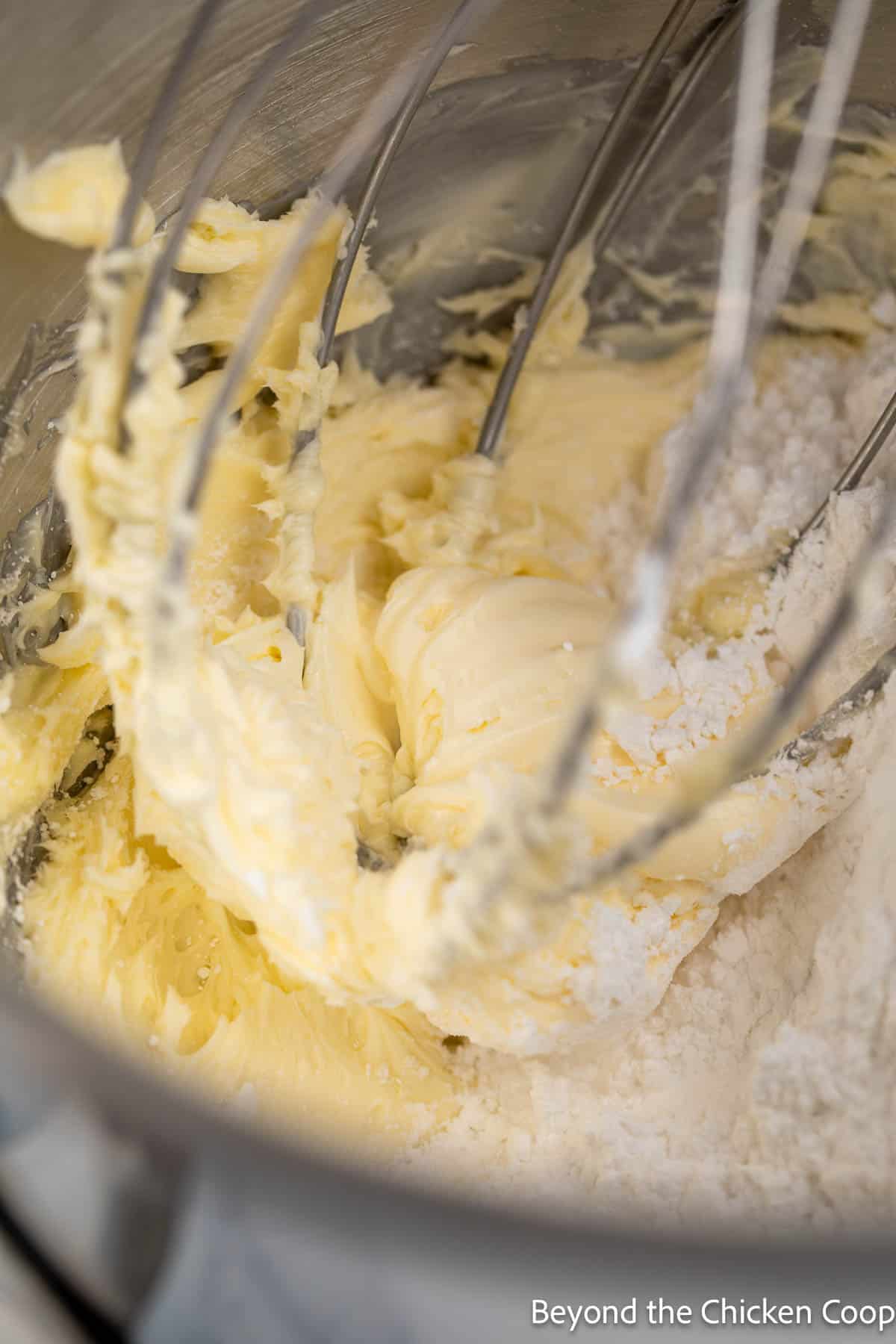 Whipped butter in a mixer with powdered sugar. 