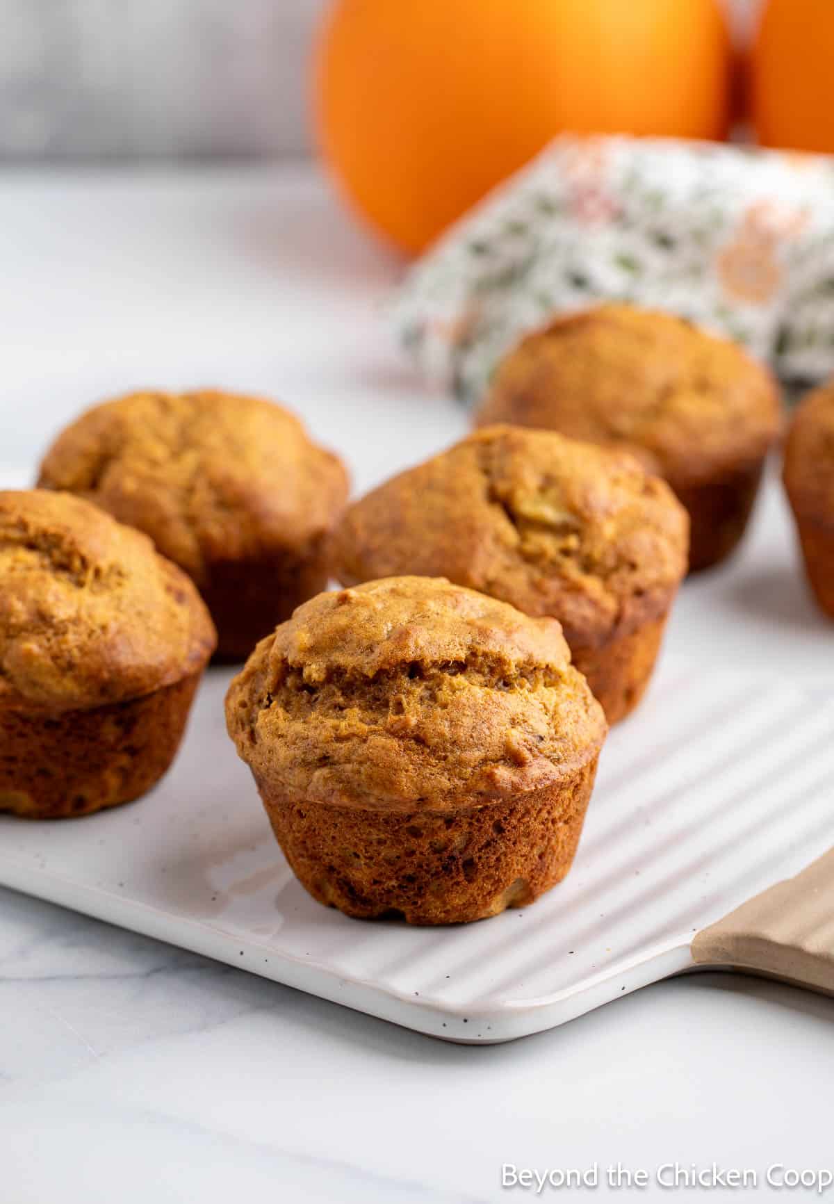 Banana Pumpkin Muffins on a white board.