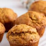 Banana Pumpkin muffins on a white serving board.