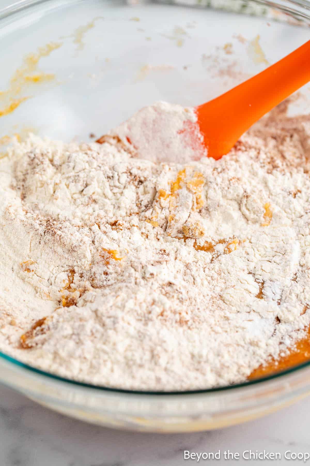 Mixing flour together in a bowl. 