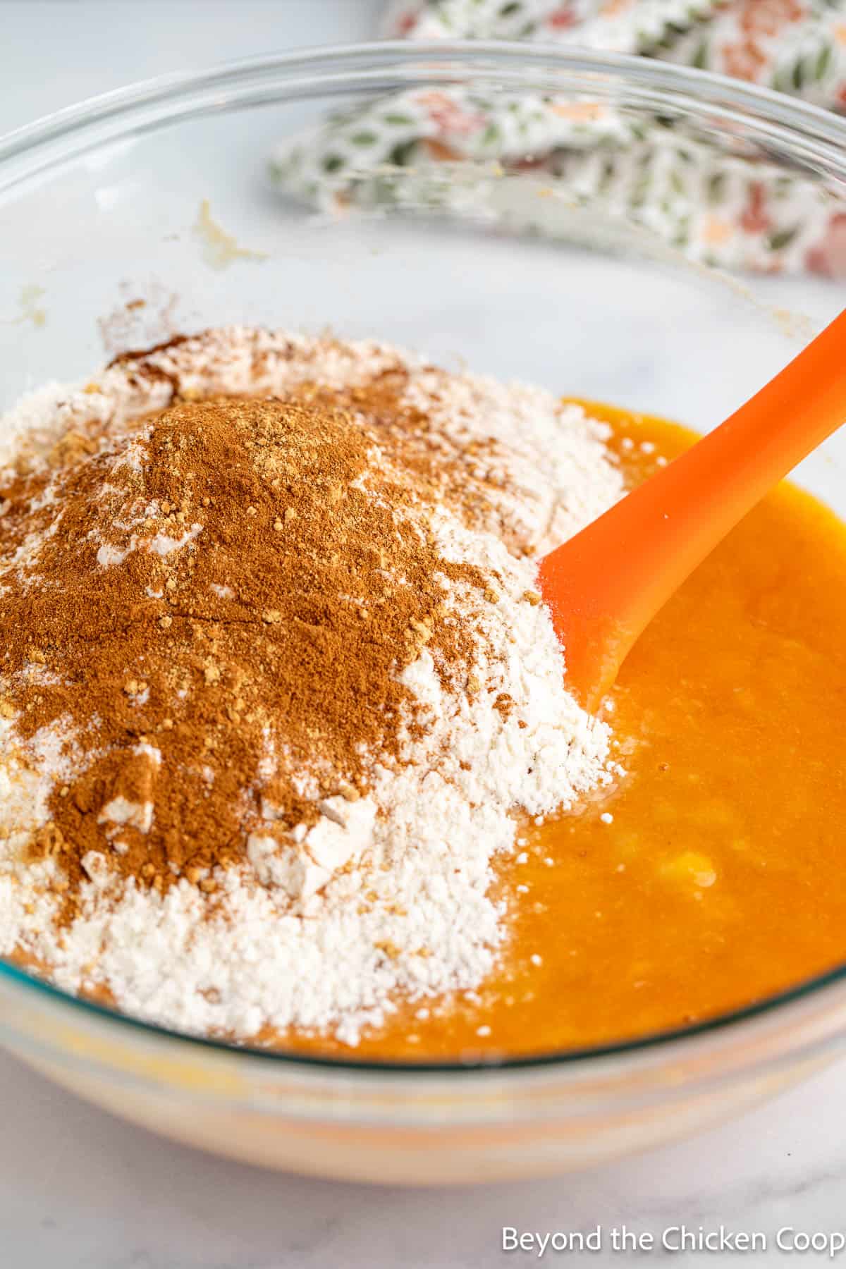 Flour with cinnamon in a bowl with pumpkin puree. 