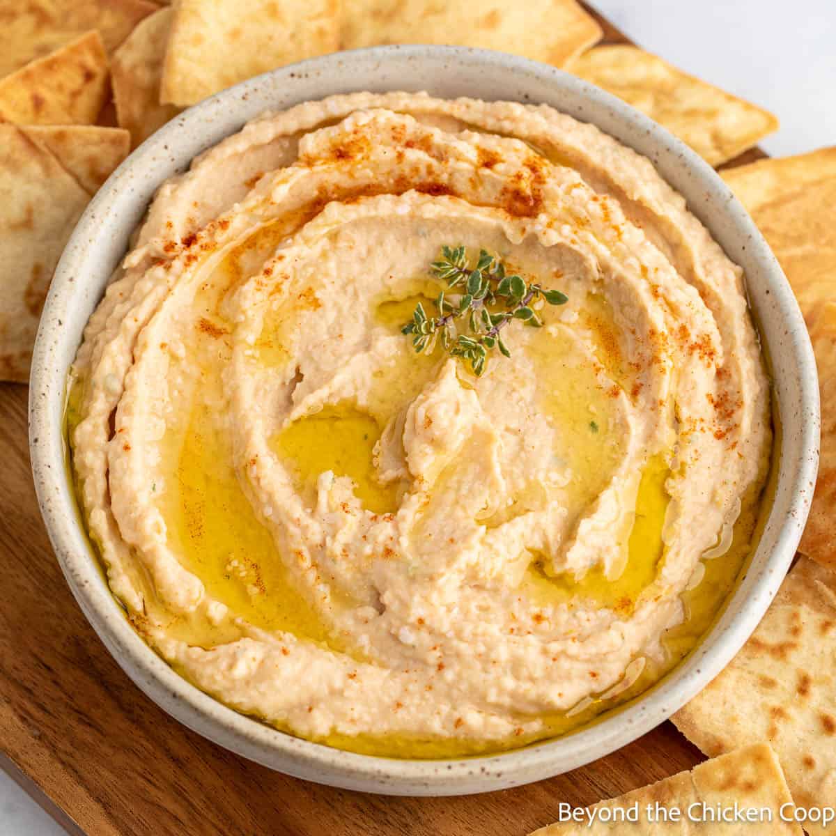 A creamy white bean dip topped with paprika and fresh thyme. 