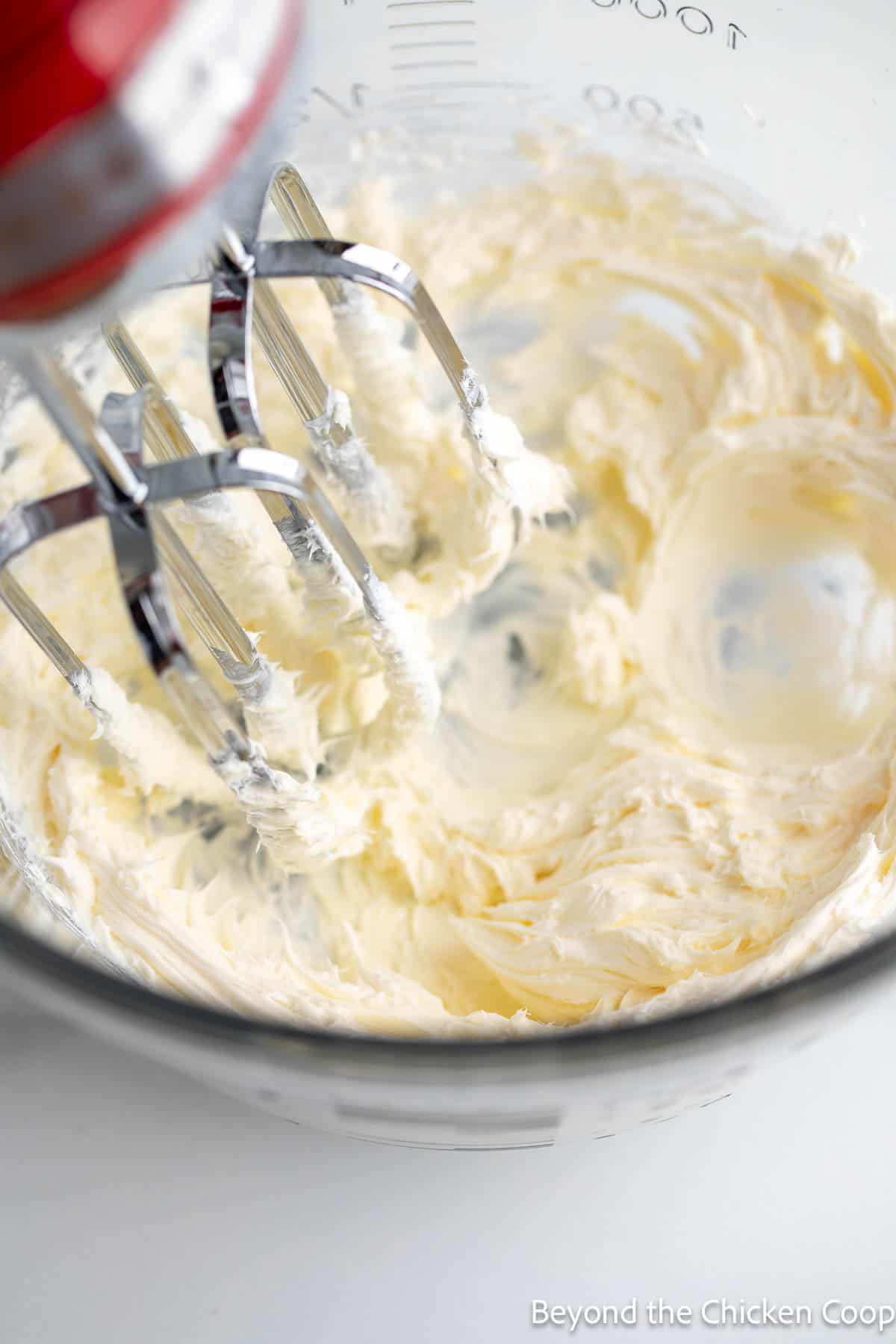 Creaming cream cheese in a mixing bowl. 