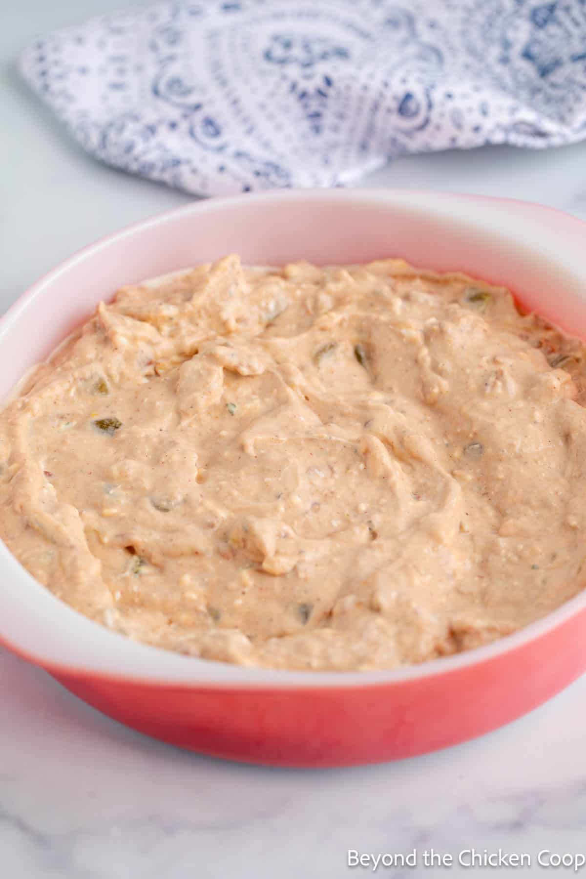 Refried bean dip in a casserole dish. 