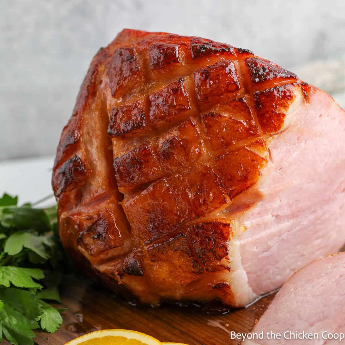 Orange glazed ham on a wooden board. 