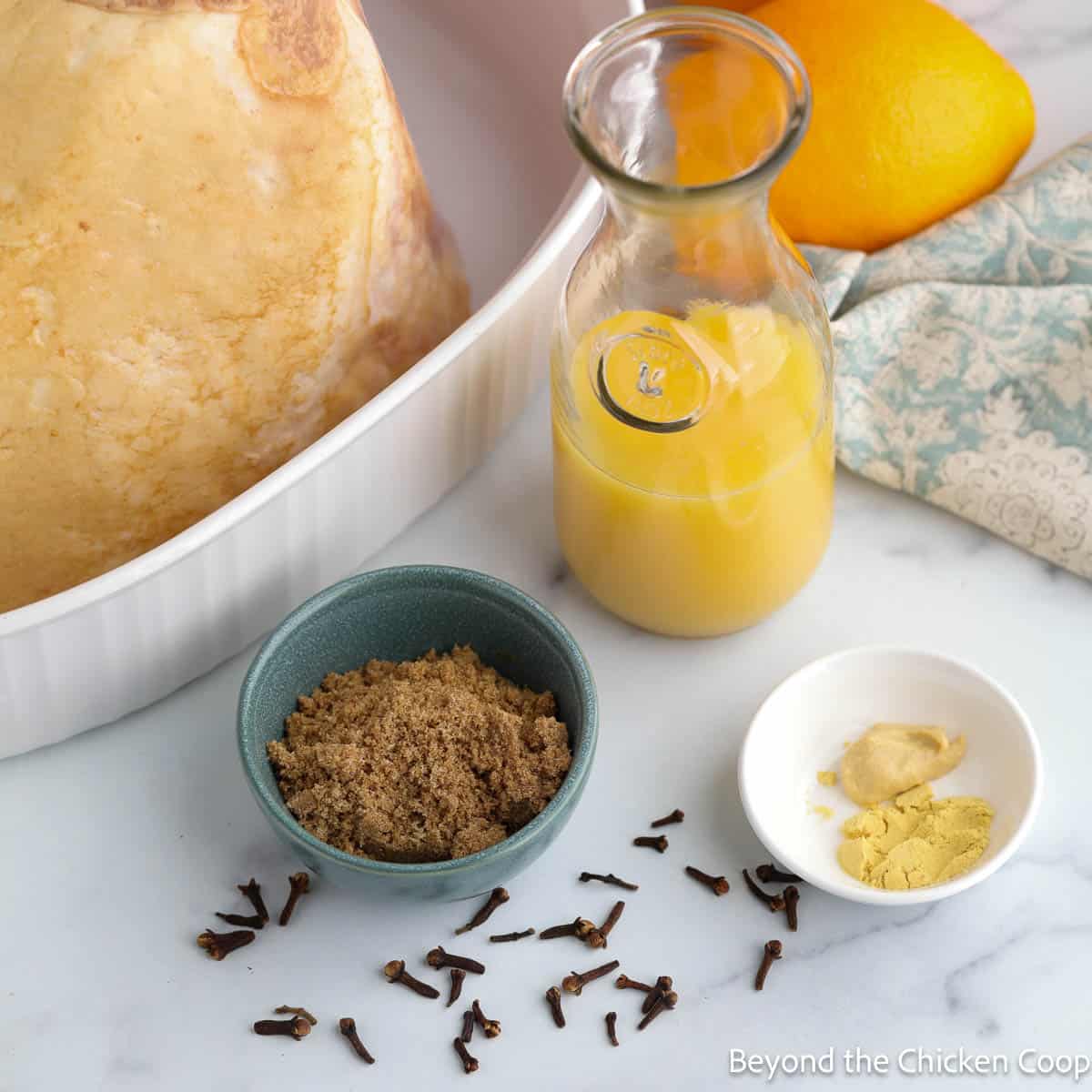 Ingredients for making an orange glazed ham.