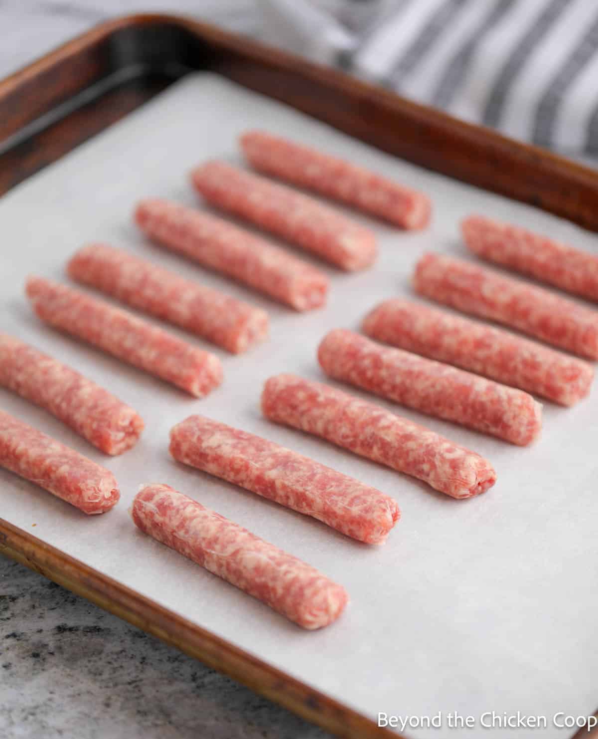 Sausage links on a baking sheet. 