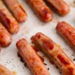 Baked breakfast sausage links on a baking sheet.