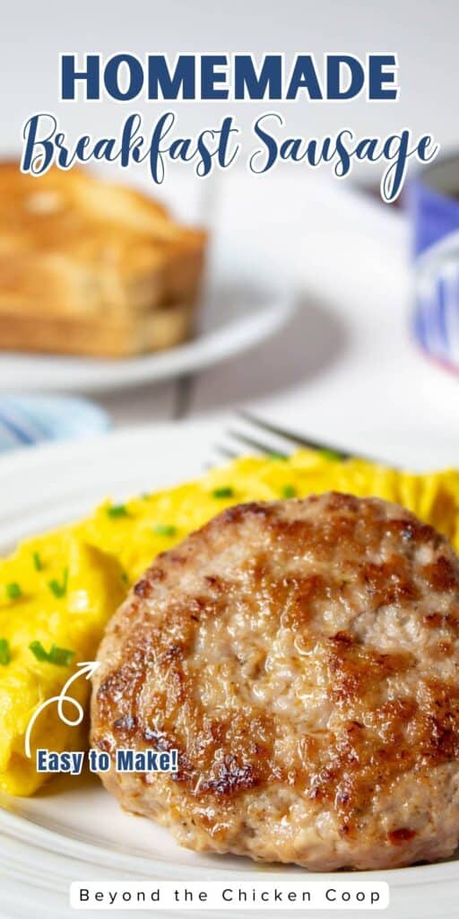Pork sausage patty on a plate next to scrambled eggs.