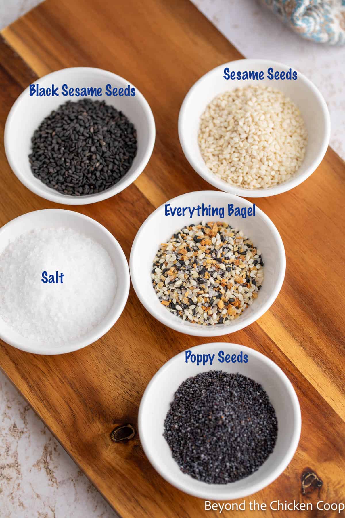 Small bowls filled with different seeds and salt. 