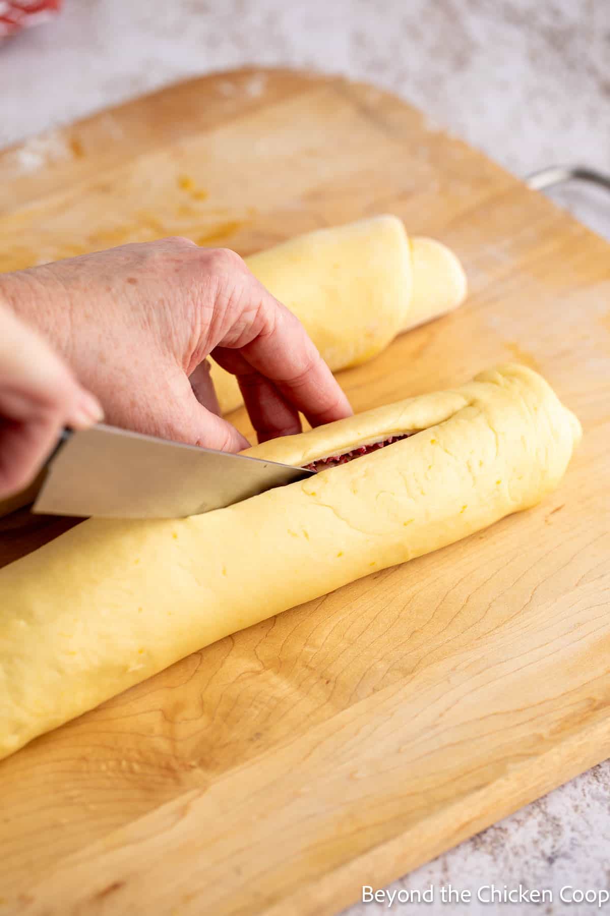 Slicing rolled logs lengthwise.