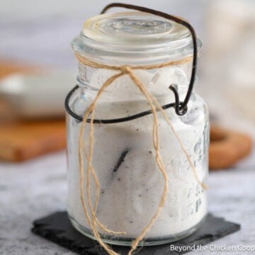An old glass jar filled with Homemade Vanilla Sugar