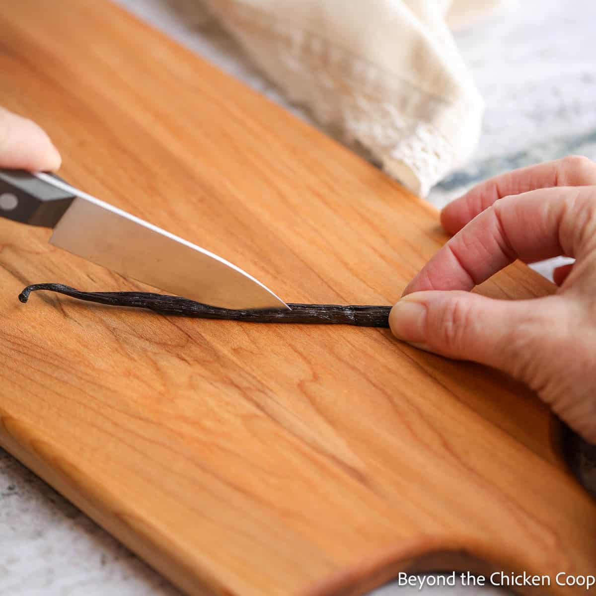 Slicing a vanilla bean in half lengthwise. 