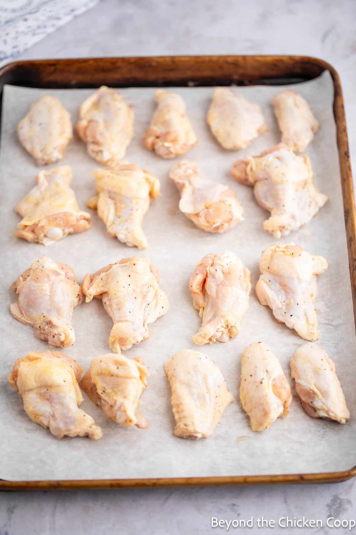 Chicken wings on a baking sheet.