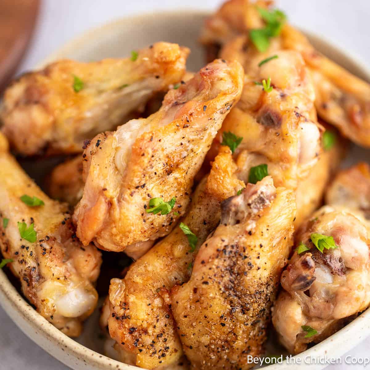 A bowl filled with Salt and Pepper Wings. 