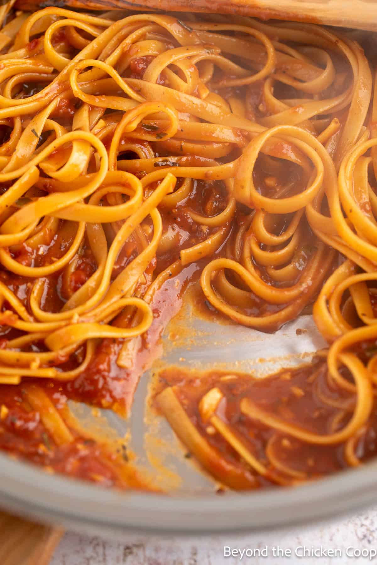 Cooking pasta in a red sauce. 