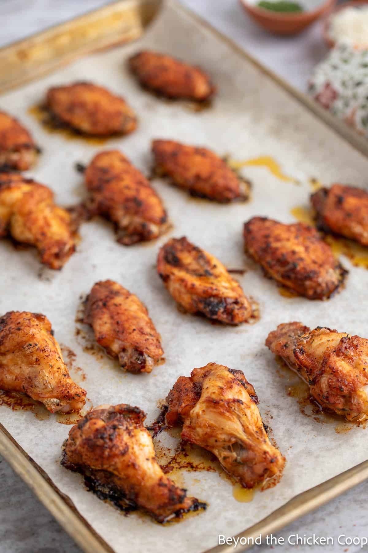 A tray full of dry rubbed chicken wings. 