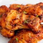 Chicken wings with a dry rub on a white plate.