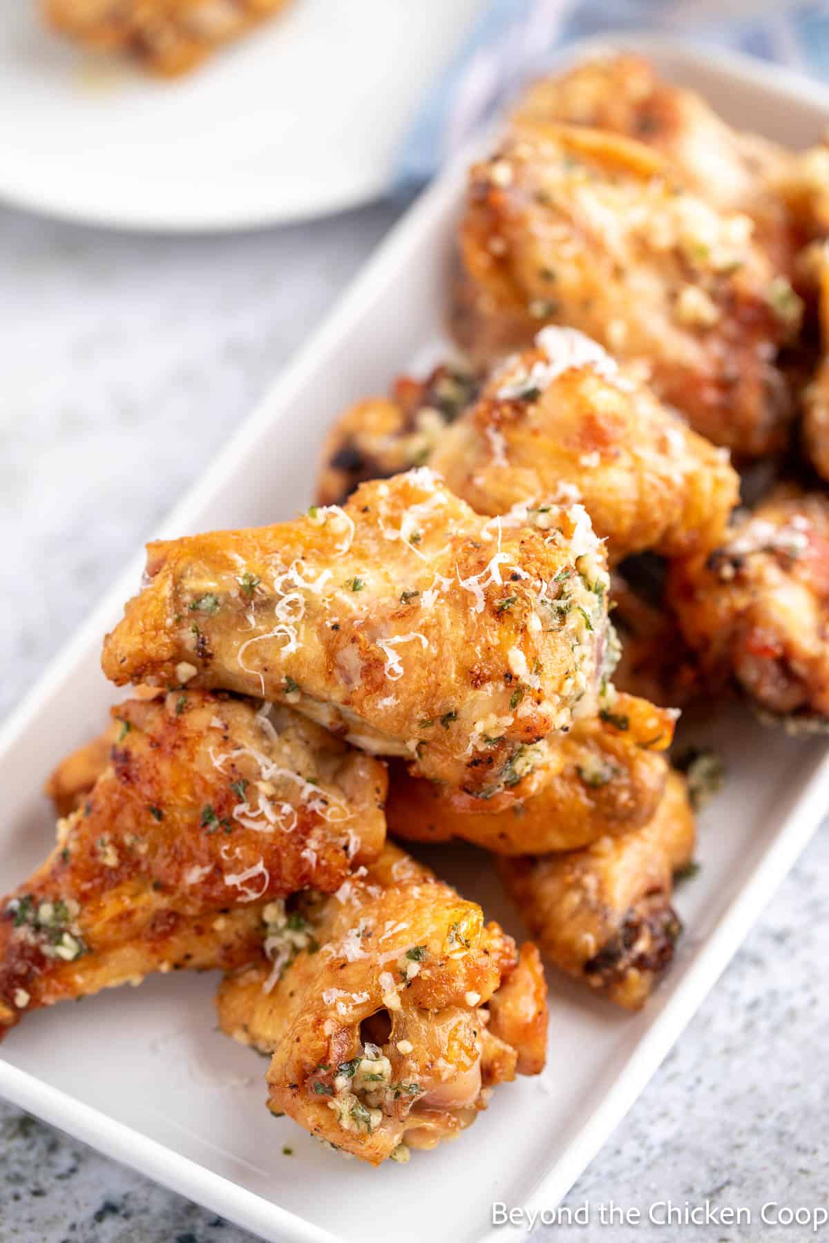 Wings topped with parmesan cheese.