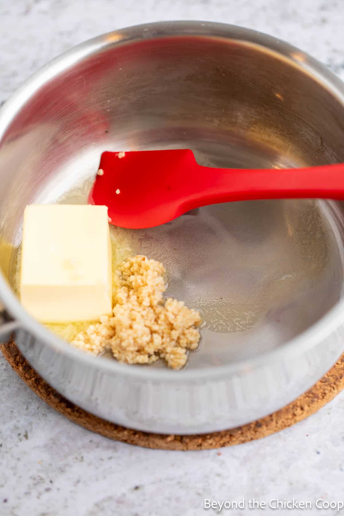 Melting butter with garlic in a saucepan. 