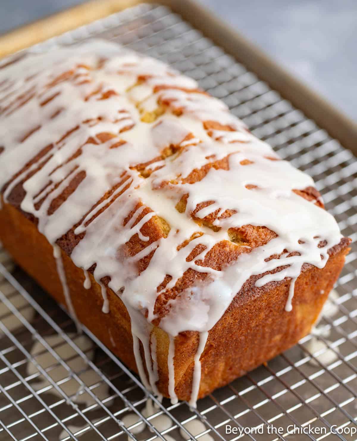 A pound cake with icing dripping off the sides. 