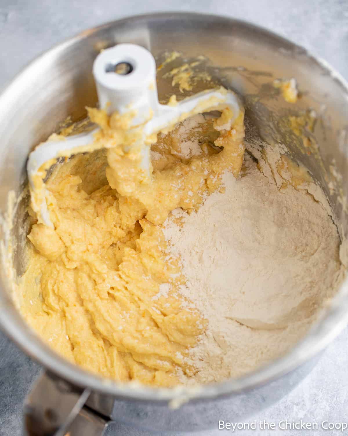 Adding flour to cake batter.