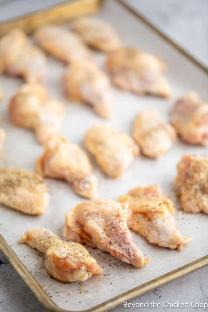 Chicken wings on a baking sheet. 