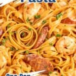 Fettuccini with shrimp and sausages in a pan.
