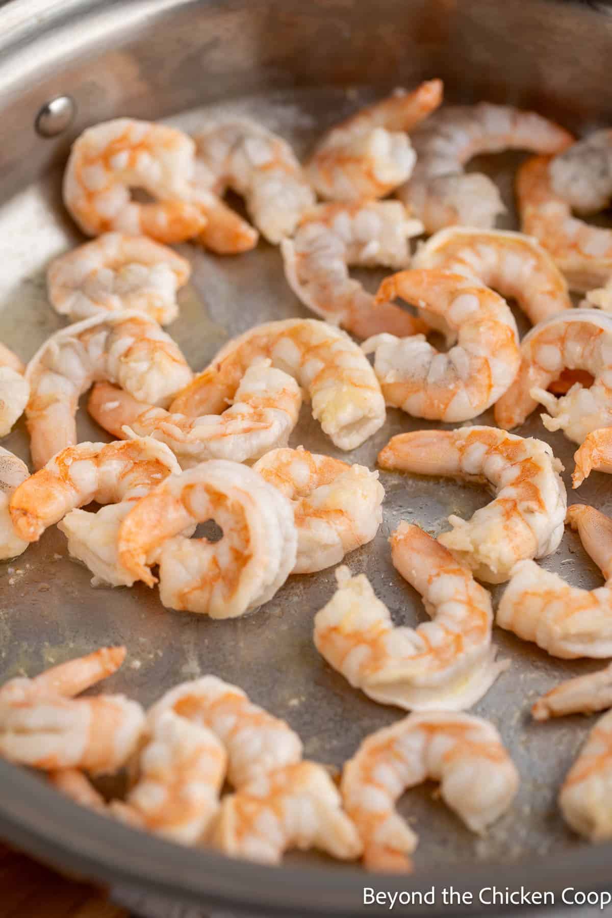 Sauteed shrimp in a skillet. 