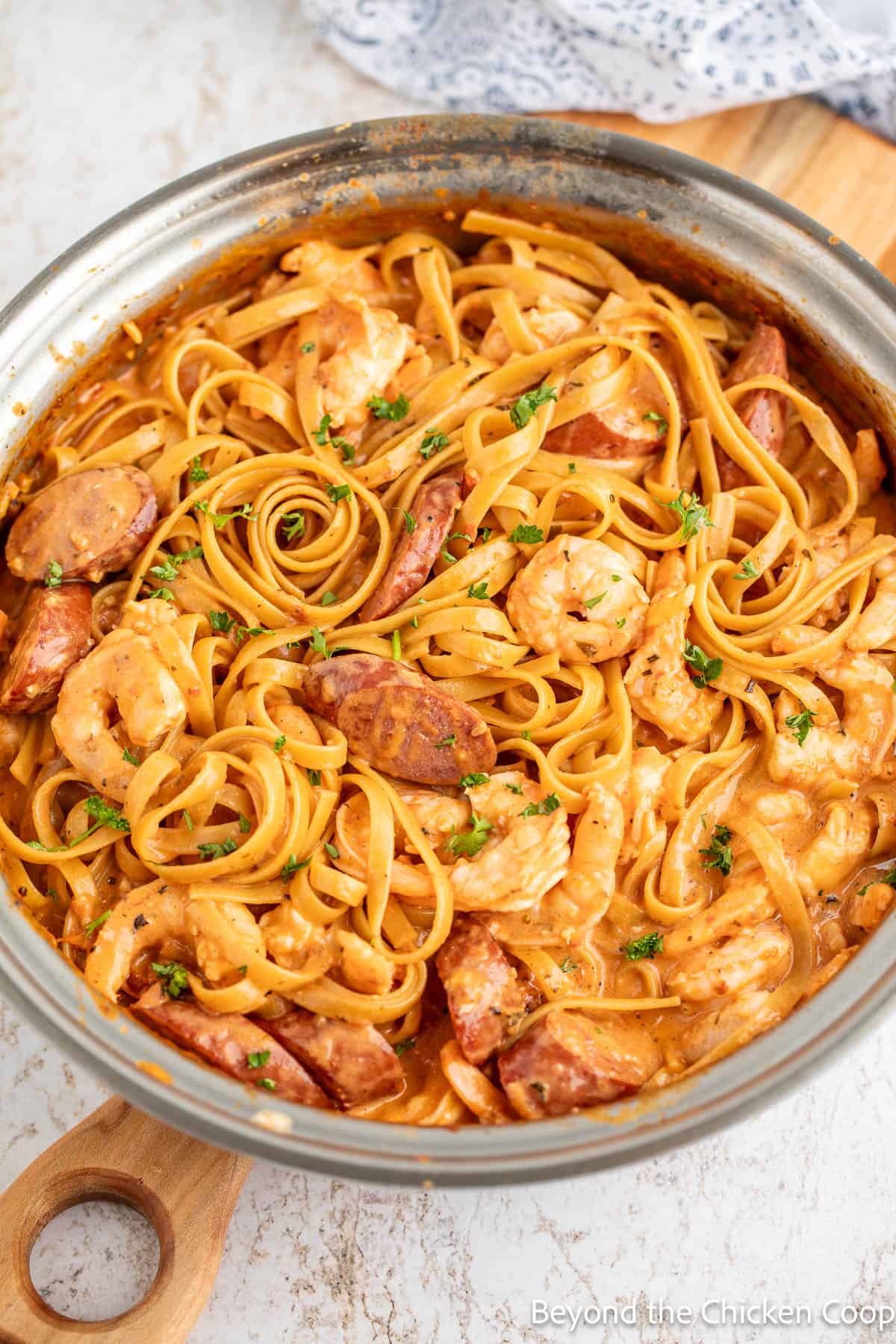 Creamy Shrimp and Sausage Pasta in a skillet. 