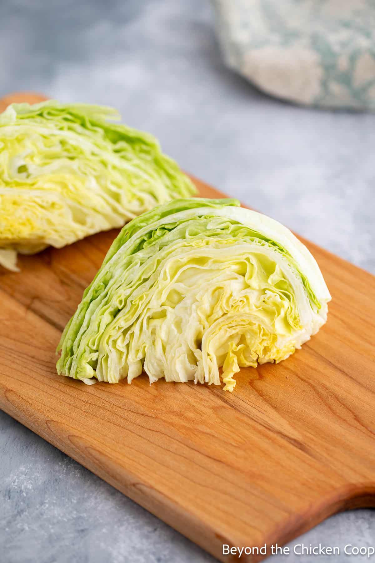 Wedges of iceberg lettuce on a cutting board. 