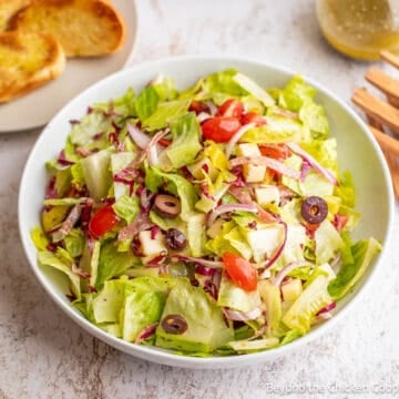 An Italian Chopped Salad in a white mixing bowl.