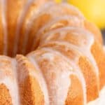 A bundt cake topped with a glaze and lemon twirls.